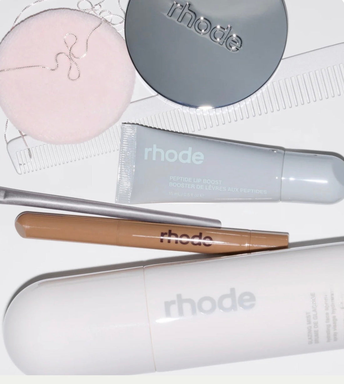 Rhode Skin minimalist skincare products including Peptide Glazing Fluid and Barrier Restore Cream